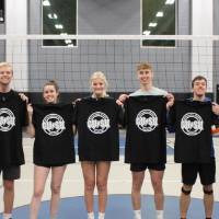Students holding up championship shirts from an upper bracket volleyball tournament